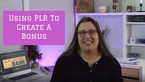 Image of a middle aged woman with brown hair in a black shirt sitting at a desk. The words "Using PLR to create a quick Bonus" are written on the screen in white letters on a pink background.